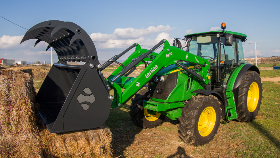 Green evolution front loader mounted on a tractor
